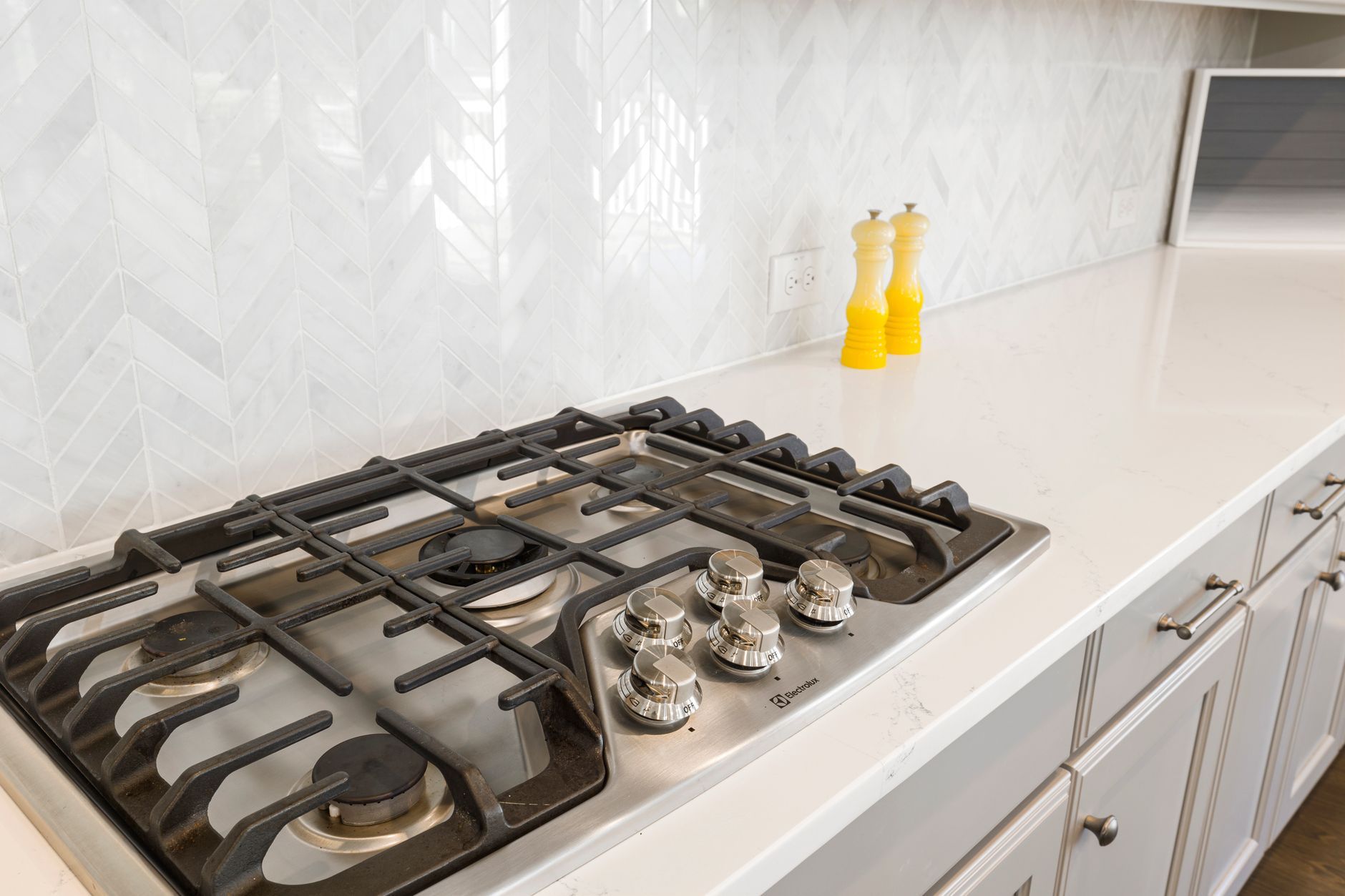 Person cleaning a gas stove top
