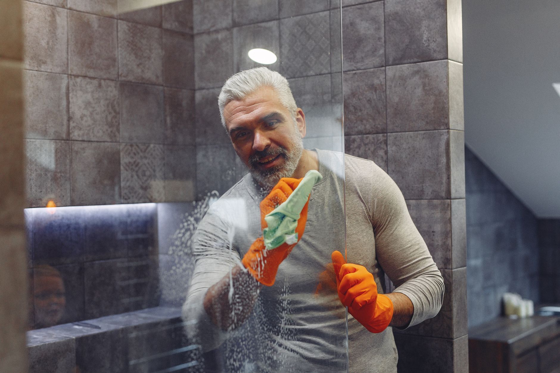 Homemade Shower Door Cleaner Recipes DIY shower cleaning supplies on a clean bathroom surface