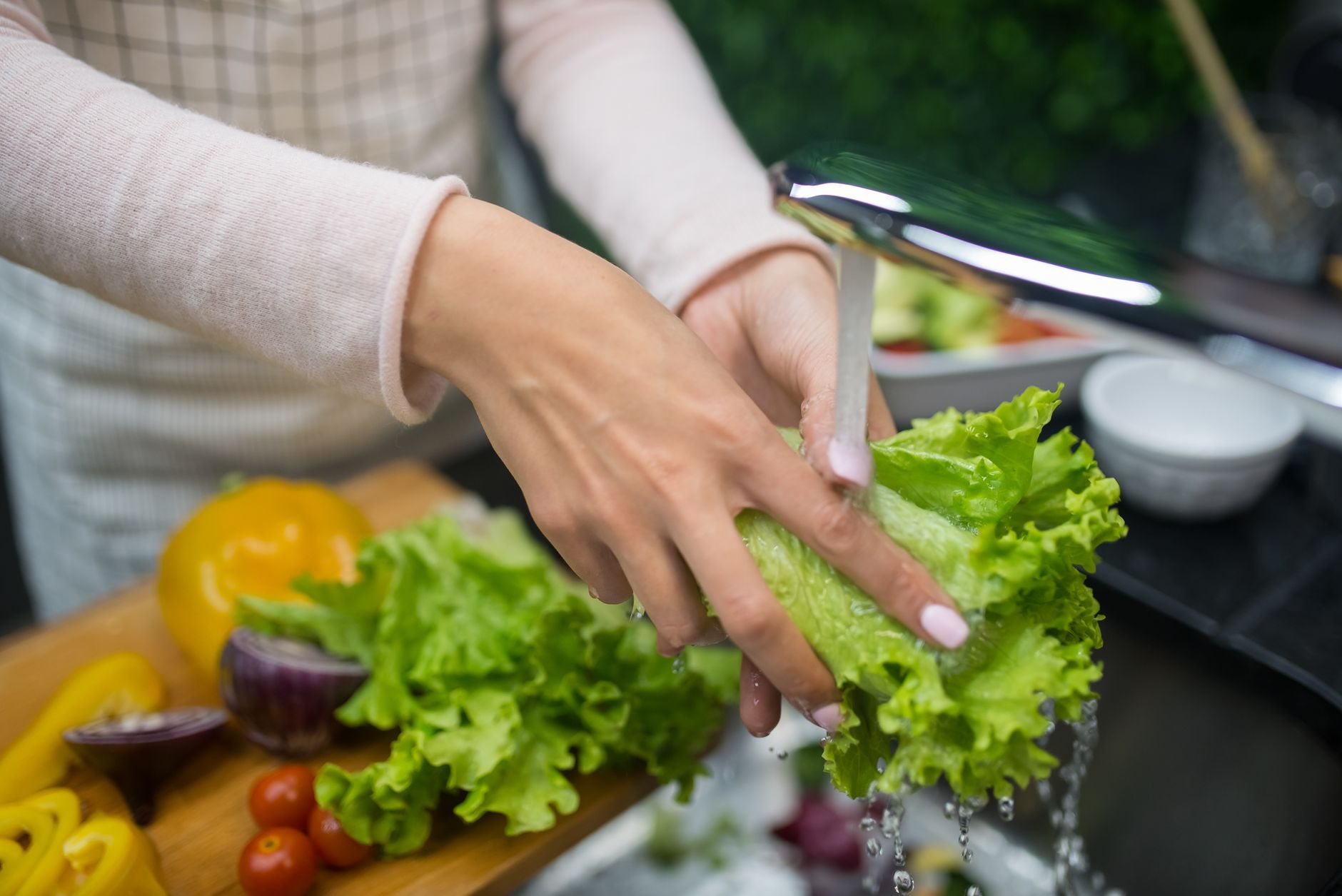 Close-up of fresh vegetables being washed in a sink with water